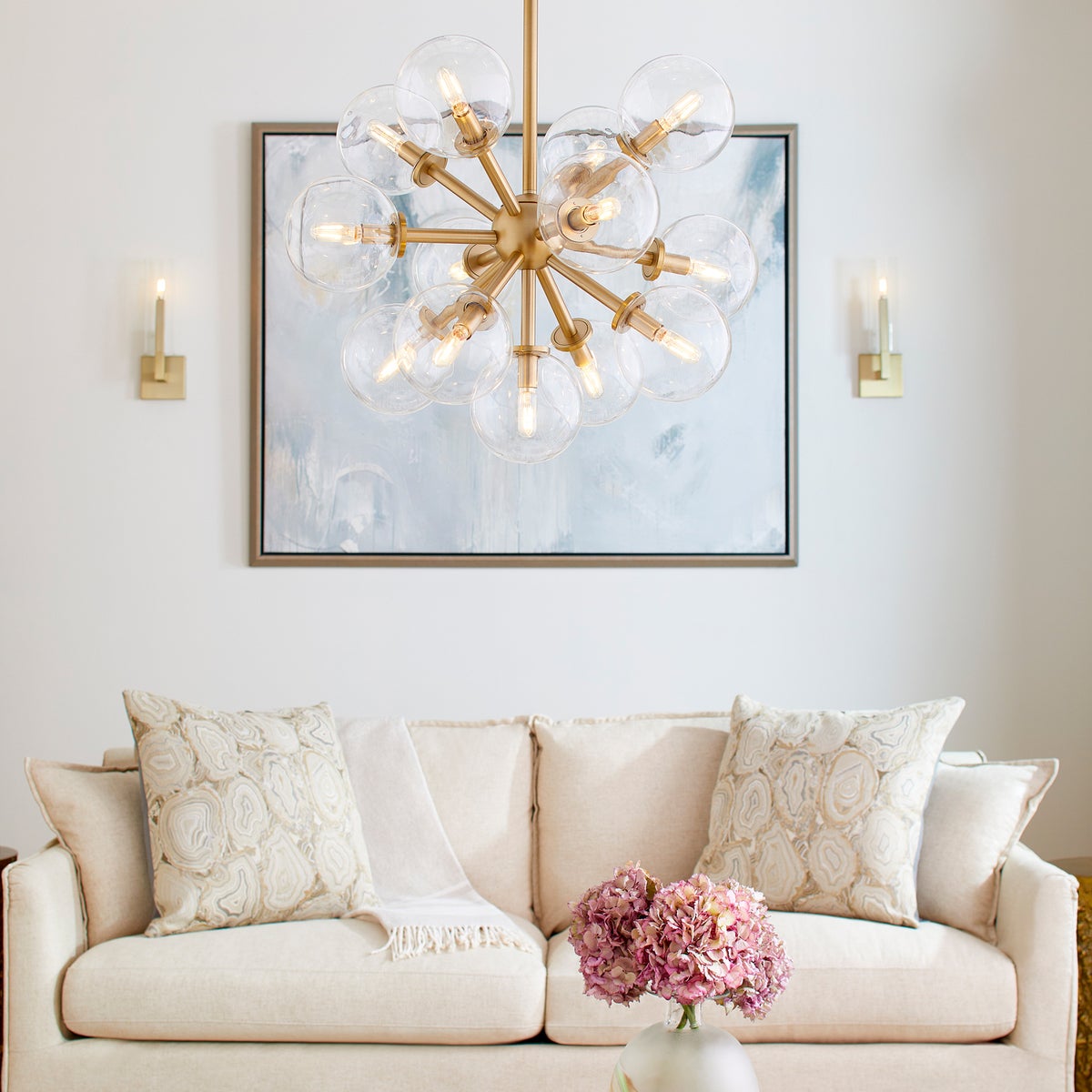 Sputnik chandelier with clear glass domes and aged brass frames, adding mid-century modern appeal. Dramatic and charming design with 13 candelabra E12 bulbs (60W, not included). UL Listed for damp locations. Dimensions: 26"W x 22"H. 2-year warranty.