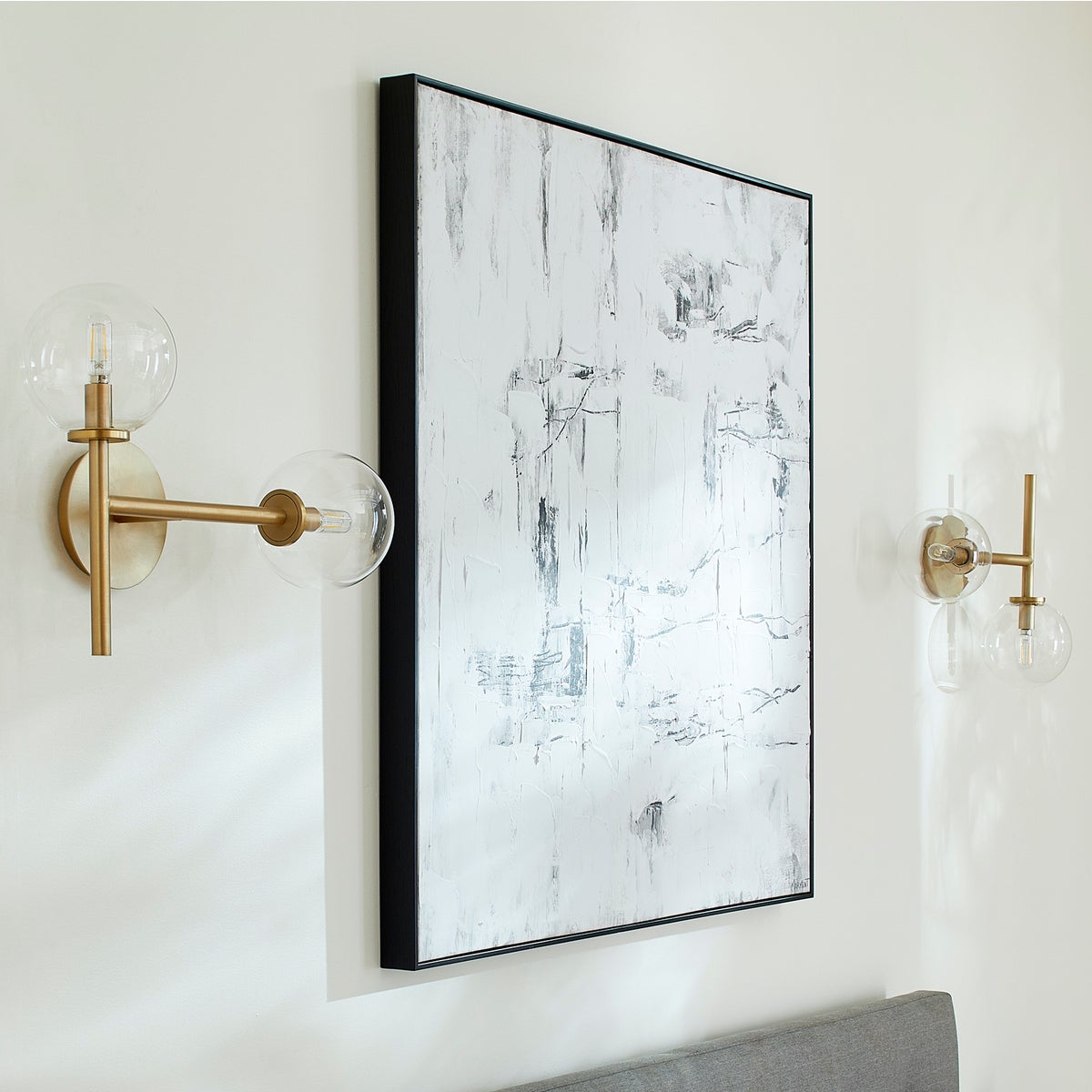 A mid-century modern Sputnik wall sconce with clear glass domes and aged brass frames. Enhance your space with this dramatic and charming lighting fixture from Quorum International.