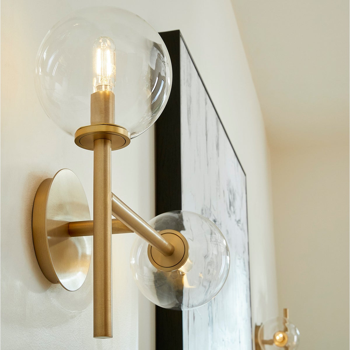 Sputnik Wall Sconce with clear glass domes and aged brass frames, adding mid-century modern appeal. Enhance your space with this Quorum International fixture.