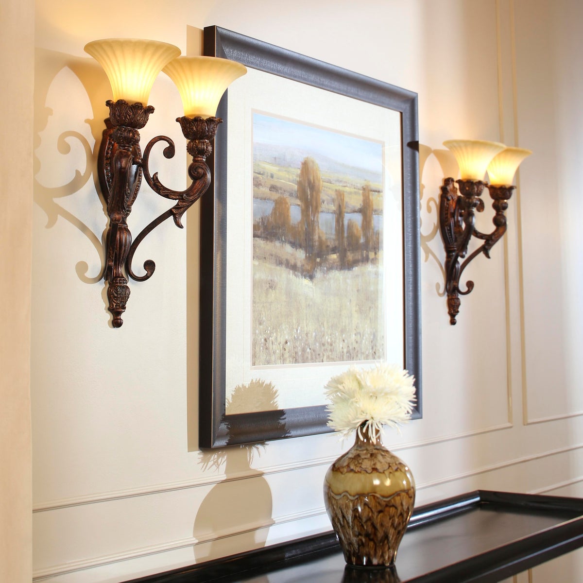 Traditional Wall Sconce with ornate detailing, corsican gold finish, and two bulbs. Classic lighting design for indoor spaces.