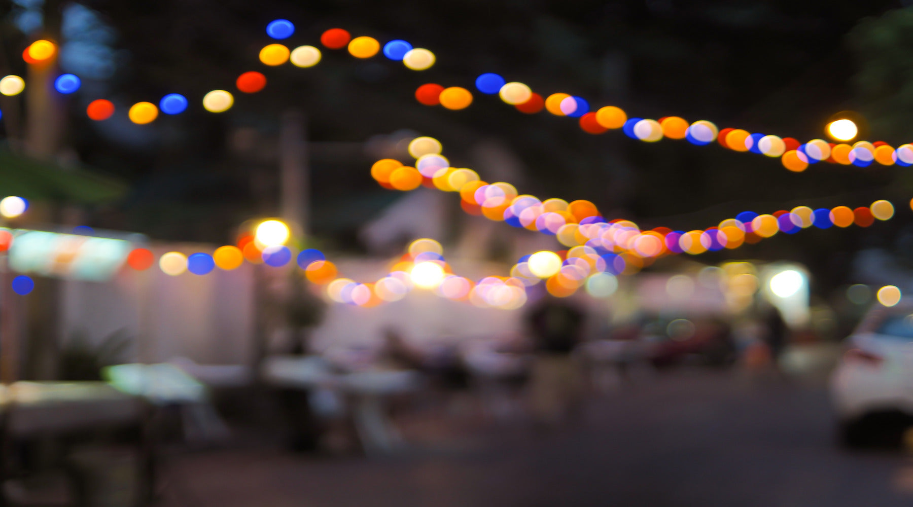 C7 LED bulbs in various colors used in string lights at festival during the night