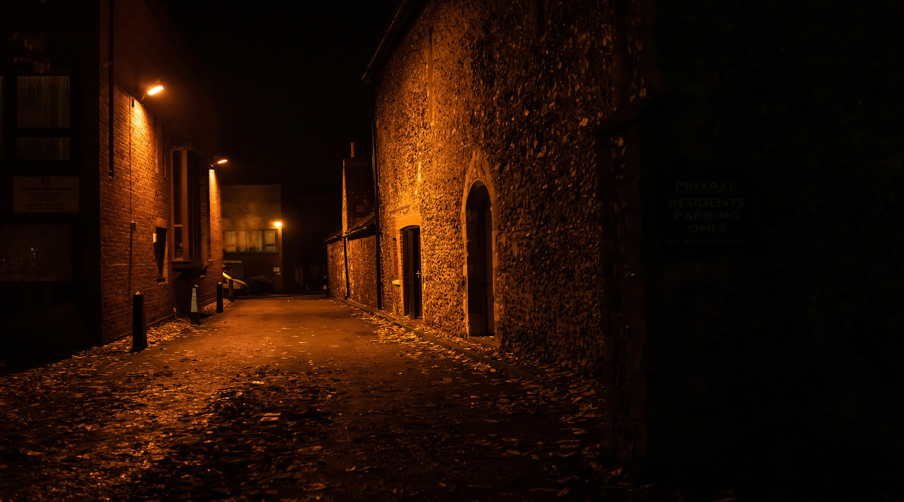City alley illuminated with LED flood lights for security and safety