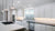 Recessed lighting installed in modern kitchen with island and white cabinetry