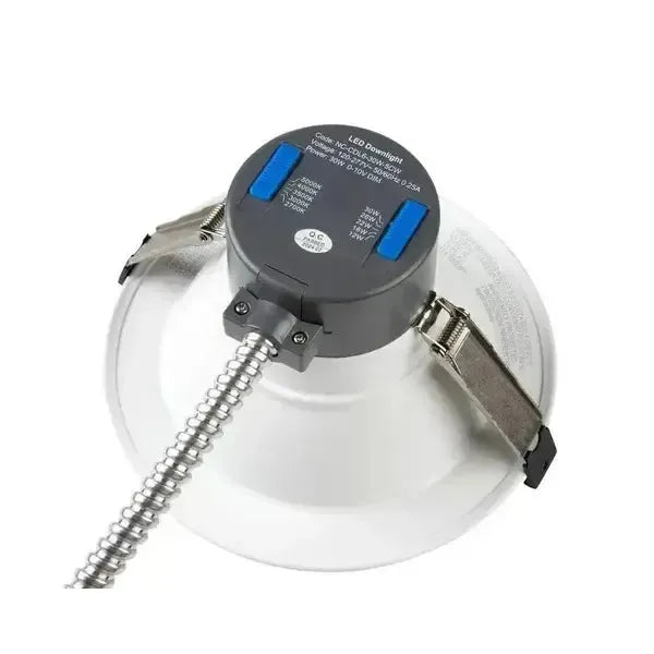 Angled top view of RecessEdge Series LED commercial downlight showing field selectable wattage and color temperature switches with housing clips and conduit connection