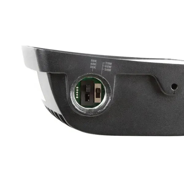 TitanBeam Series LED flood light close up side view showing open access port housing selectable CCT and wattage dip switches for field configuration