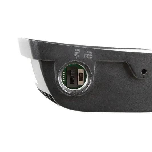 TitanBeam Series LED flood light close up side view showing open access port housing selectable CCT and wattage dip switches for field configuration